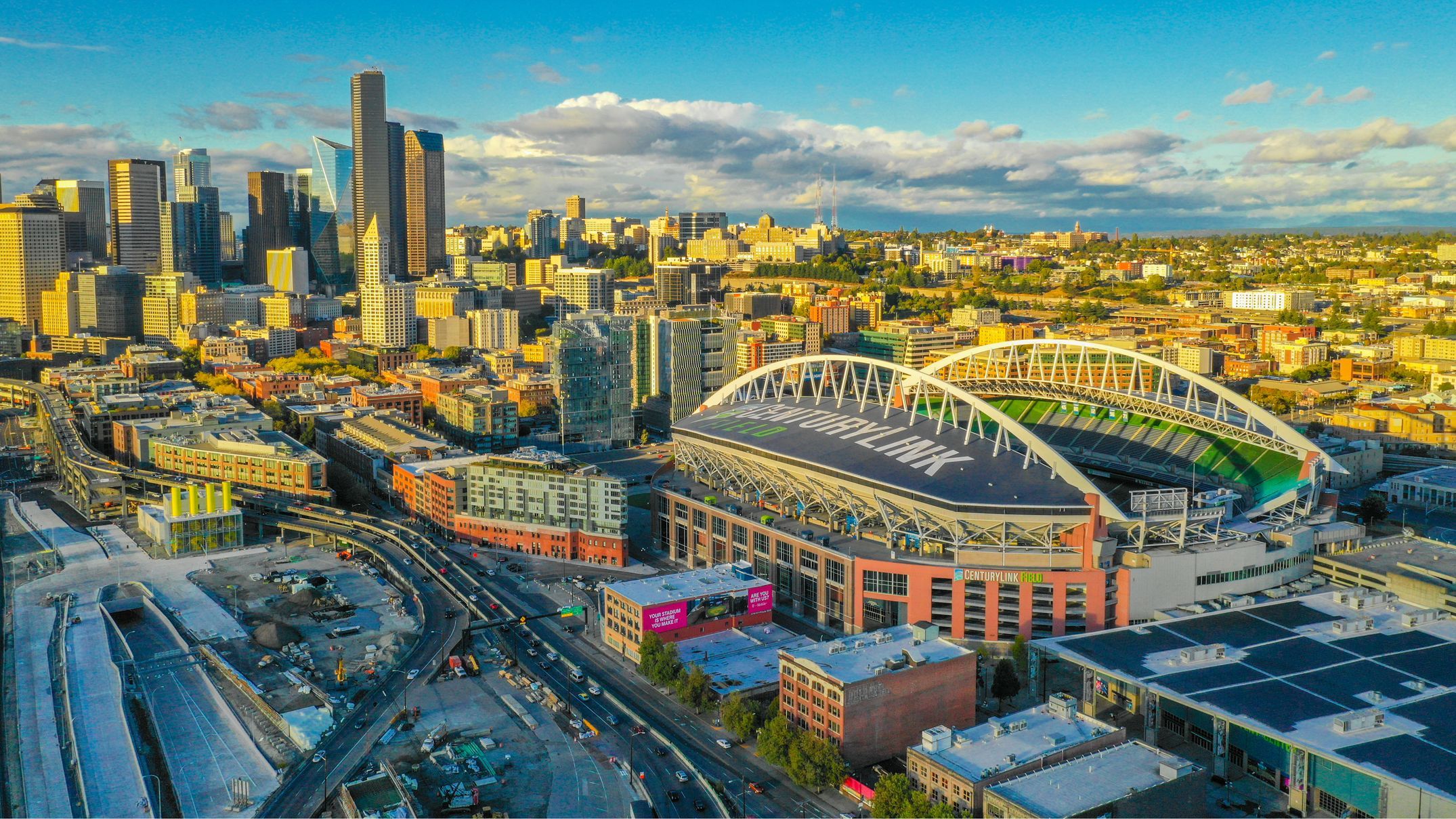 Aerial view of a city skyline with a large stadium.