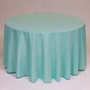 Round table covered with a light blue tablecloth.